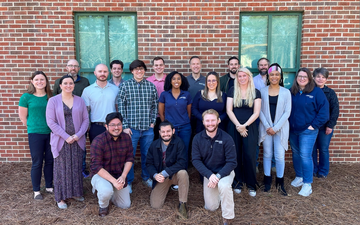 Repair-Shop-Websites-Team (1) The Repair Shop Websites team, based in the USA, poses for a group photo in front of a red brick building with two green-tinted windows.